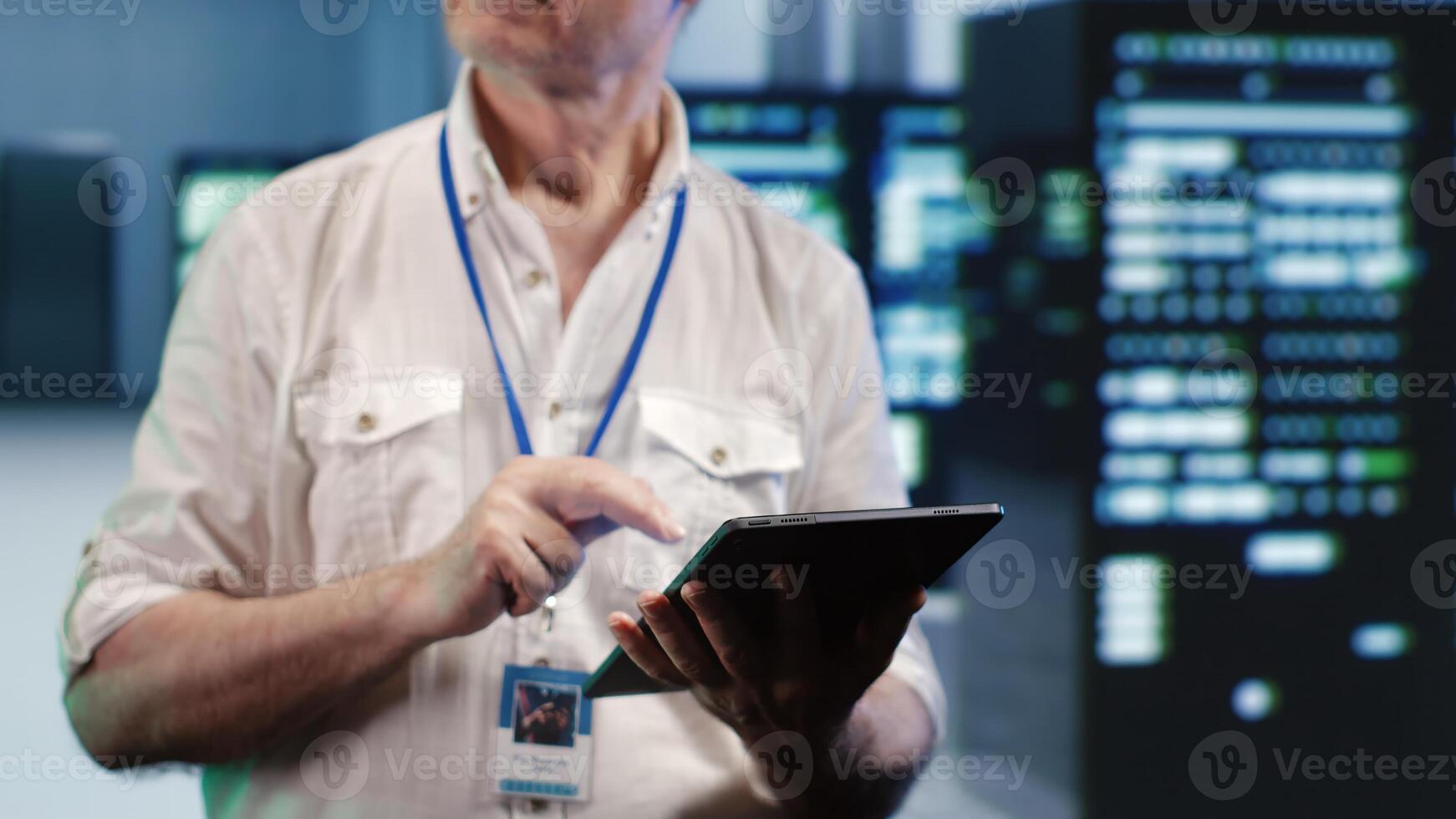 Hardworking repairman expertly managing data while navigating through industrial server cabinets. Productive admin ensuring flawless cybersecurity shielding, optimizing systems photo