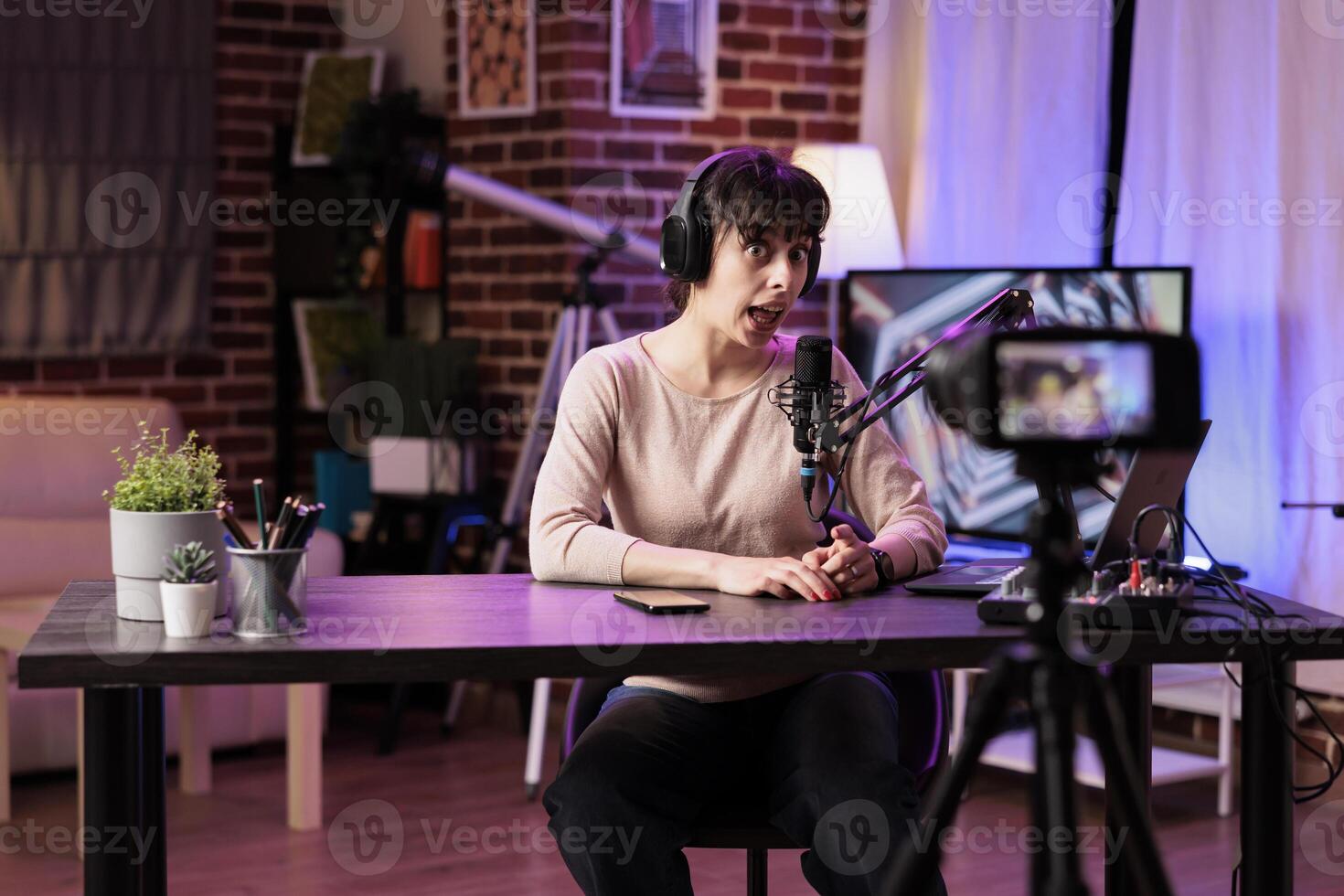 Vlogger recording internet show using professional camera, talking about entrepreneurship subjects. Influencer filming live broadcast for her audience using streaming equipment photo
