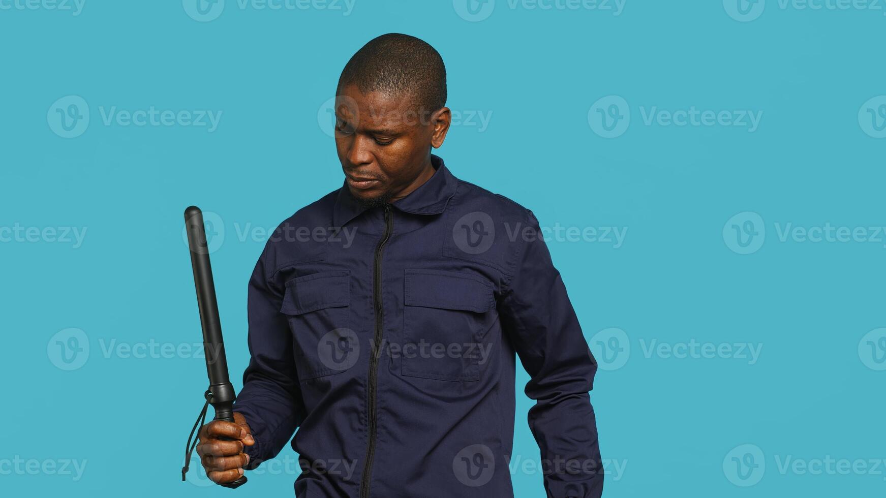Security guard tasked with restricting unwanted access looking to sky, praying. Portrait of bodyguard waiting for miracle, doing spreading arms gesture, studio background, camera A photo