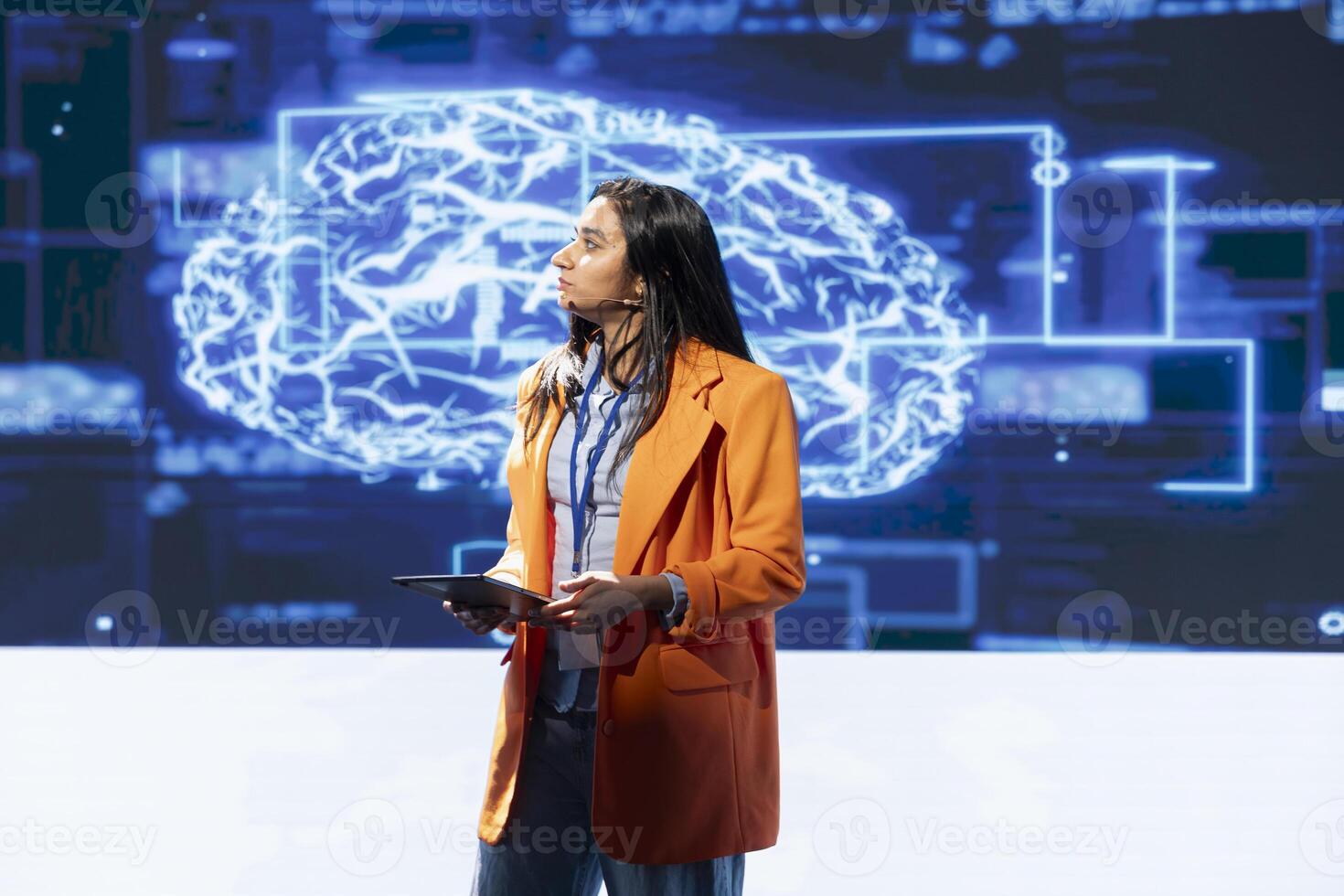 CEO holding tablet speaking at event bringing together leading researchers and companies to explore latest developments in AI and machine learning. Expert using device to hold tech presentation photo