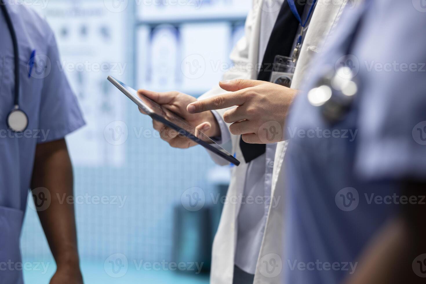 Physician consulting with his staff to analyze x ray checkup results in cabinet, discussing about potential treatment plan for a certain diagnosis. Medical team with radiology expertise. Close up. photo