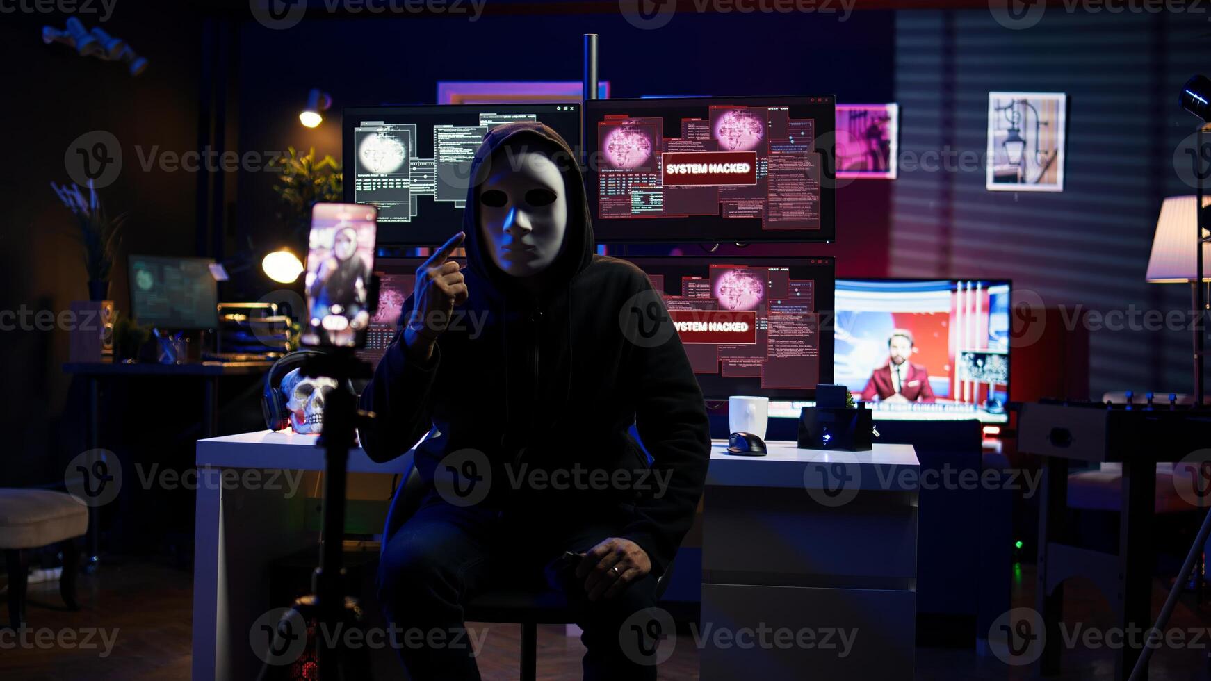 Hacker concealing identity filming ransom in hidden underground base, threatening to release stolen data publicly if payout demands are not met, using phone to record blackmail footage, camera B photo