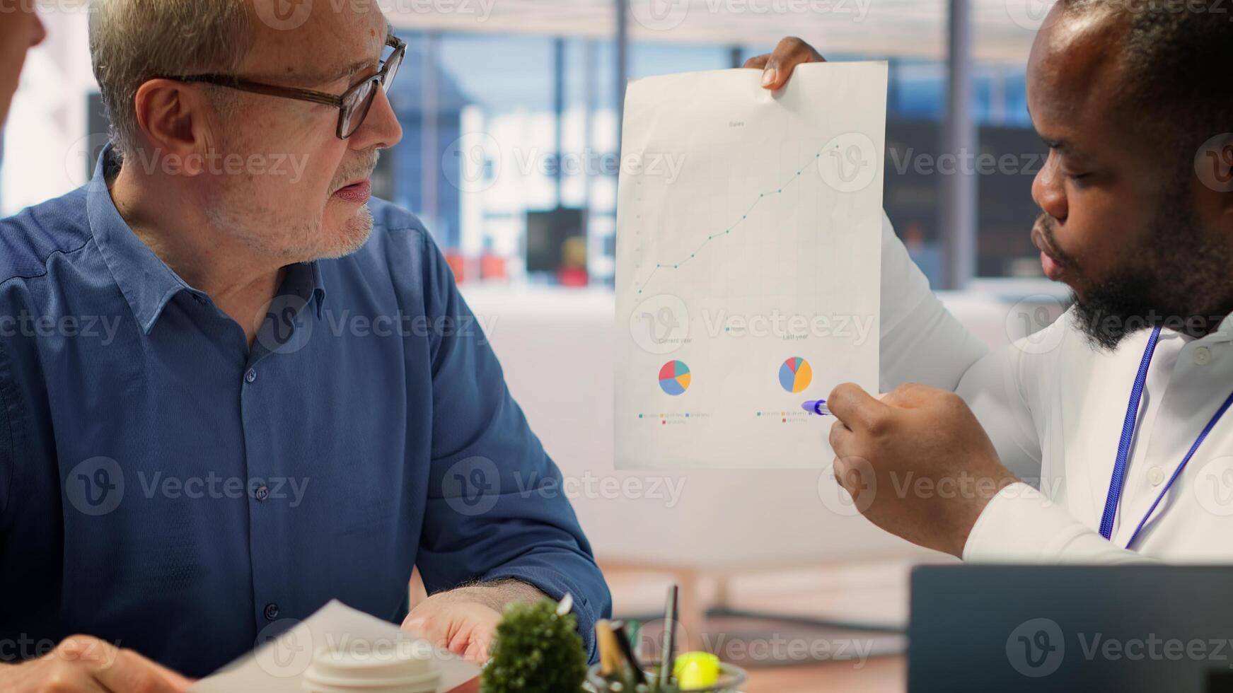 Financial adviser presenting retirement plans available at the agency, counseling meeting with mature senior people. Securing life insurance and savings after being retired, bank deposit. Camera A. photo