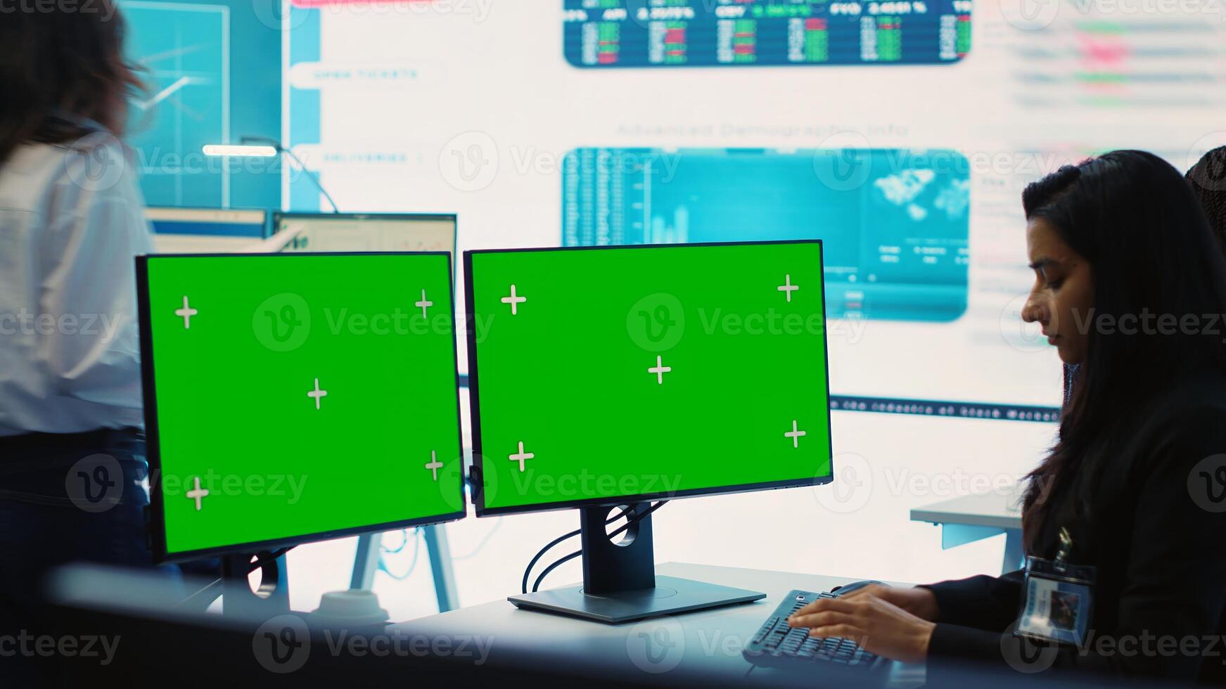 Executive officer analyzing greenscreen on monitors at his workstation, find ways of increasing organizational funds to expand the business globally. Isolated mockup screen in control room. Camera A. photo