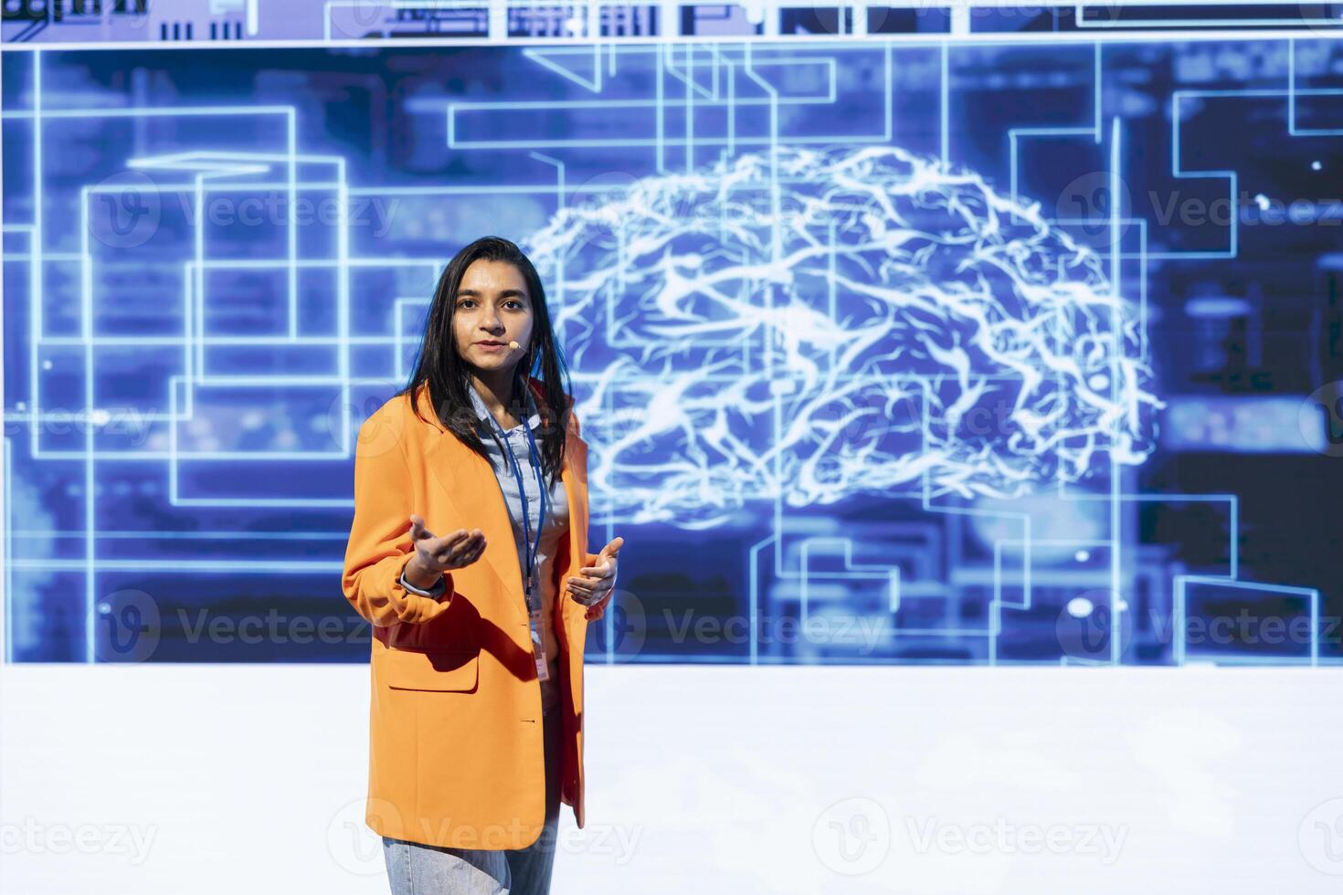 Tech startup leader using convention as platform to offer latest AI services and products. Businesswoman uses microphone to talk with investors interested in artificial intelligence photo