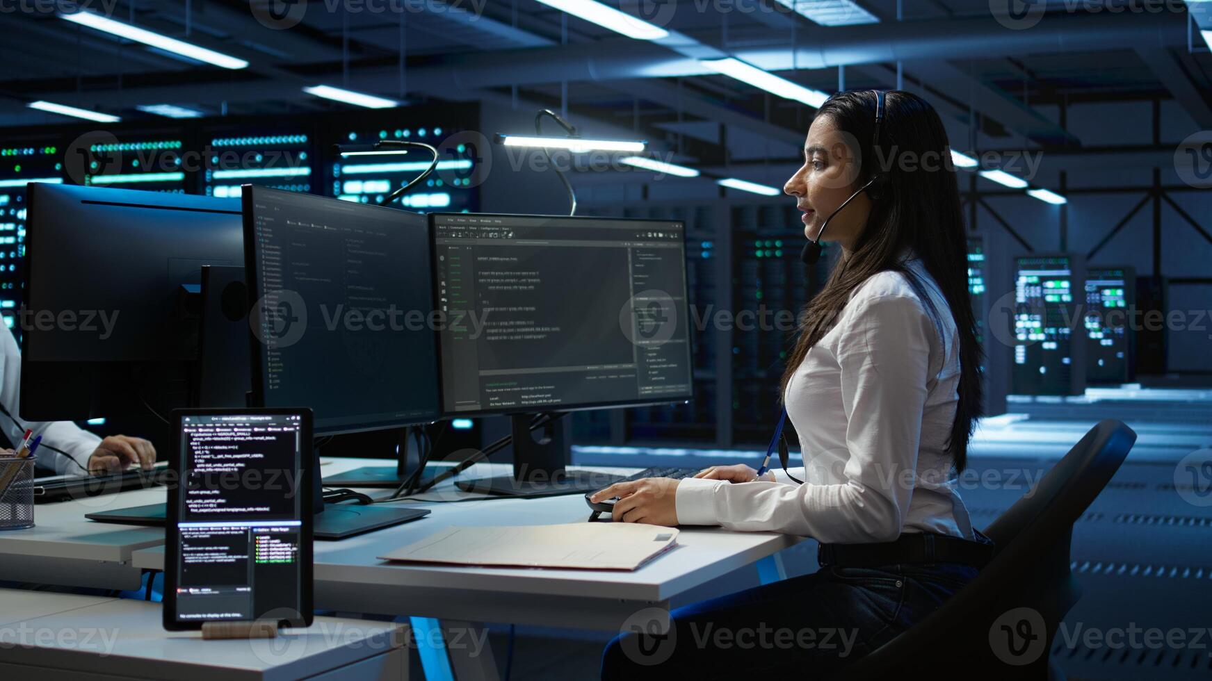 Technician in data center provides technical support to users, troubleshooting issues, close up. Server hub workers carrying out operational technical interventions requested by clients, camera B photo