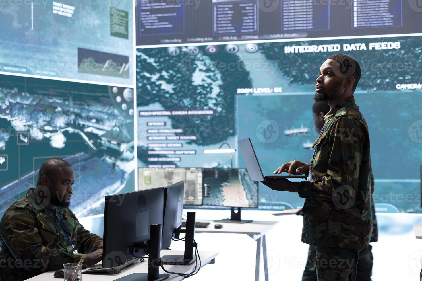 Military control room features army personnel monitoring surveillance systems, soldiers integrating data and coordinating strategic missions. Support decision making and efficiency. photo