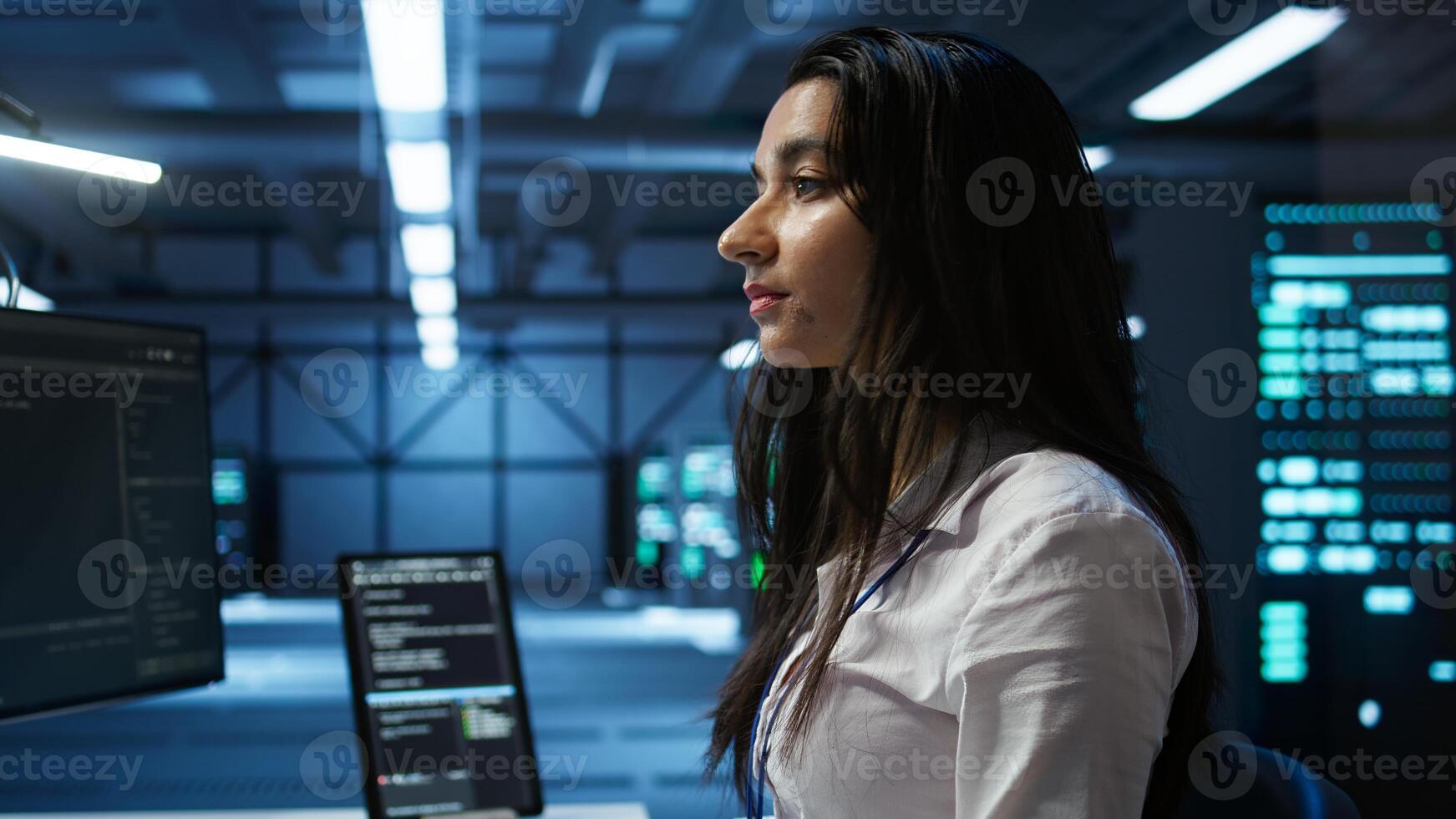 IT specialist in data center providing technical support to customers, troubleshooting issues. Server farm worker carrying out operational technical interventions requested by clients, camera B photo