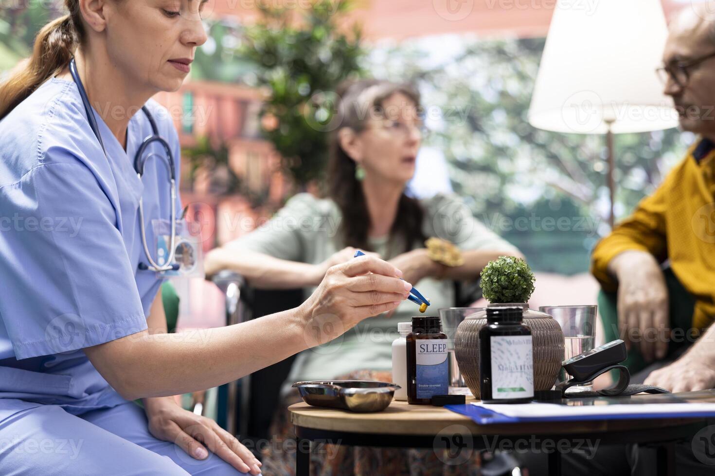 Social caregiver separating the medicaments and supplements pills, preparing daily doses for both senior people at home. Putting the capsules in two different bottles, healthcare medicine. photo