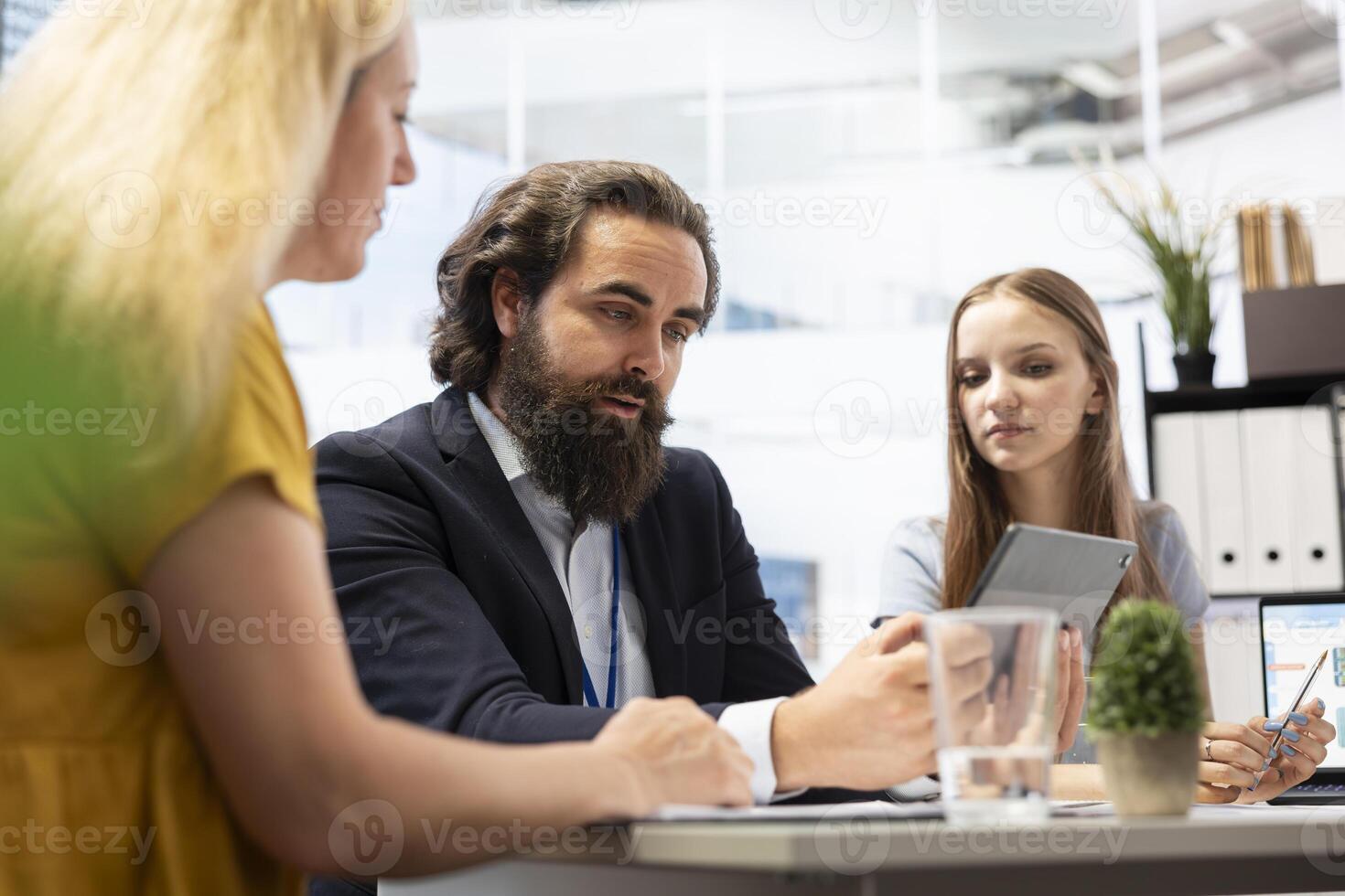Financial advisor helping family members in office, offering economic services such as analyzing financial markets, developing investing strategies and monitoring stock market portfolio photo