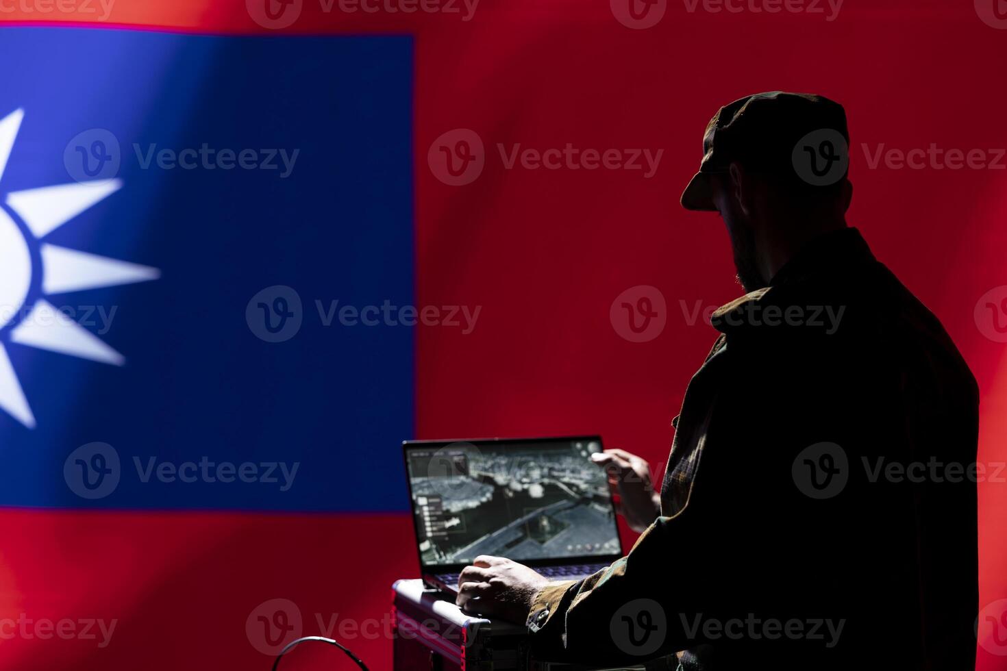 Intelligence officer isolated over Taiwan flag monitoring China border using radar. Taiwanese freedom fighter engaged in surveillance mission using laptop, looking at world map photo