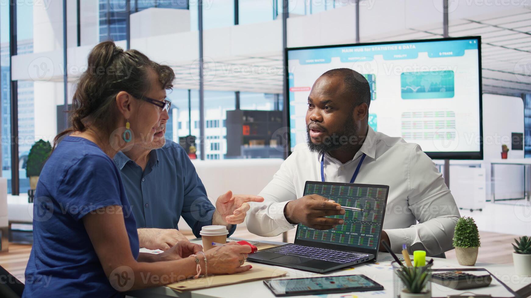 Elderly couple consulting with a financial advisor to create a detailed retirement plan, focusing on savings, investments and ensuring a comfortable future. Life insurance and finances. Camera B. photo