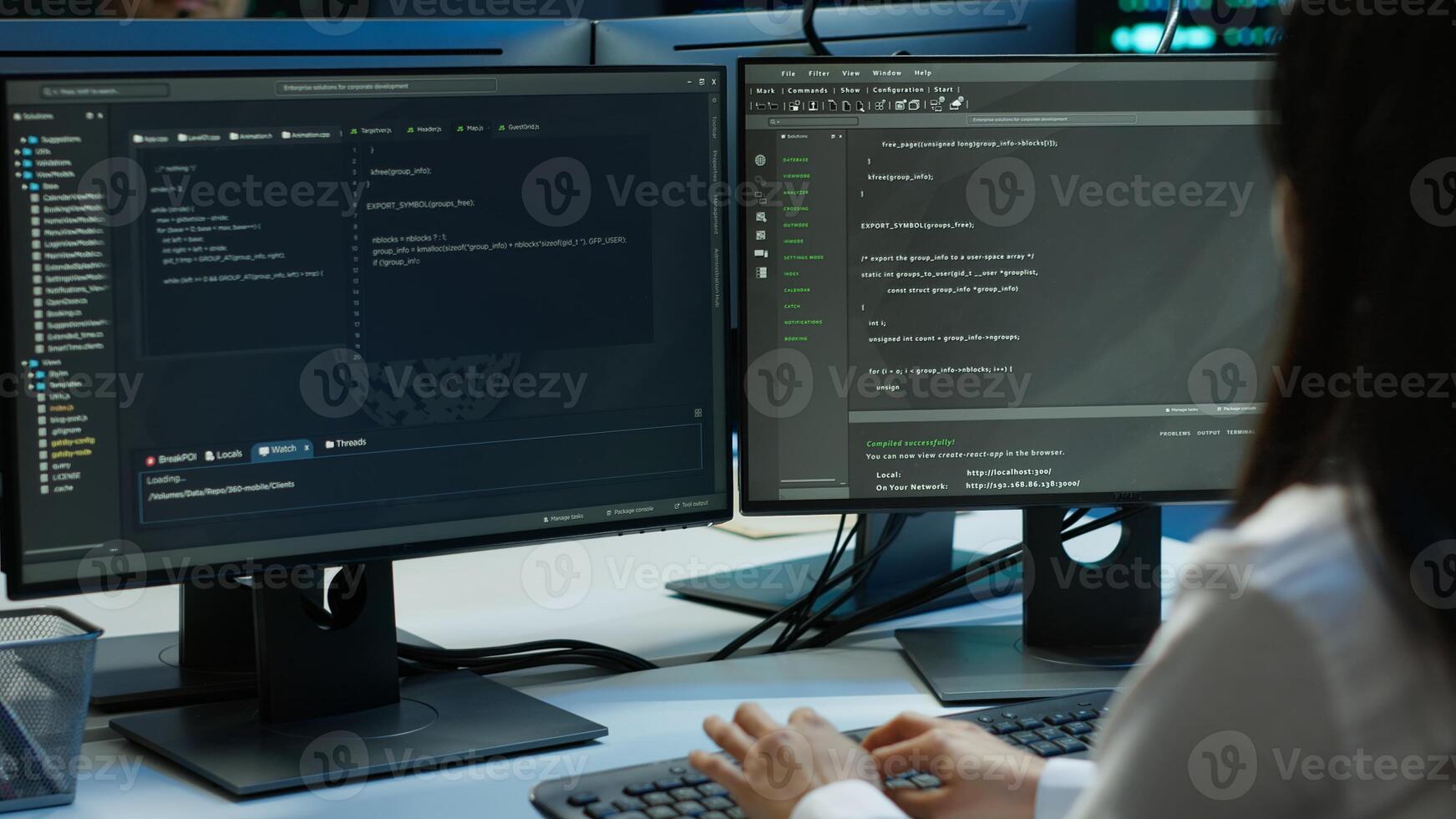 Software developer in data center ensuring system can handle networking tasks. IT professional in server room tracking network traffic with PC, making improvements, camera A photo