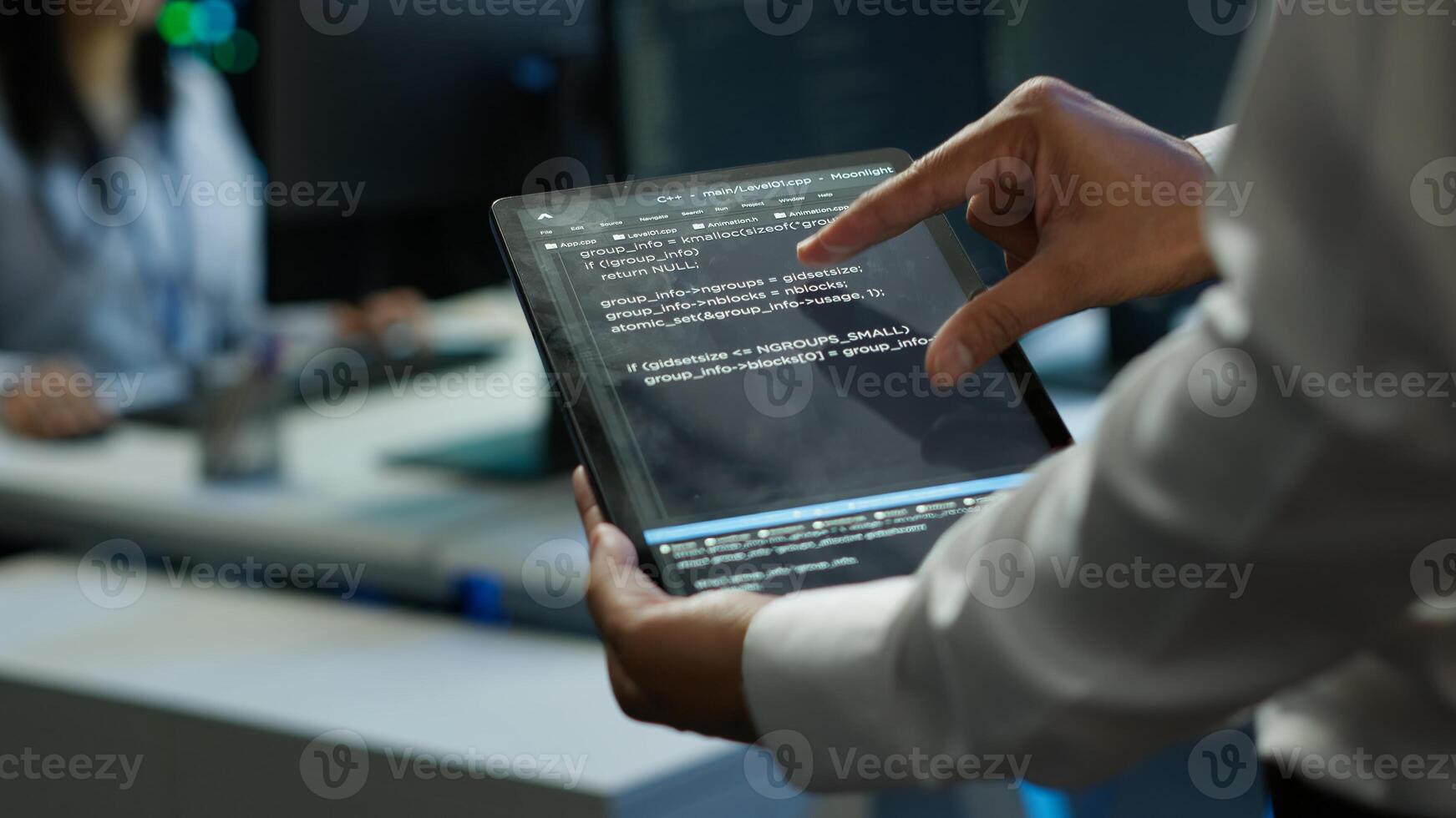 Programmer using device in data center, managing servers, operating systems. Close up of specialist in server hub using tablet to ensure networks are secure and functioning properly, camera A photo