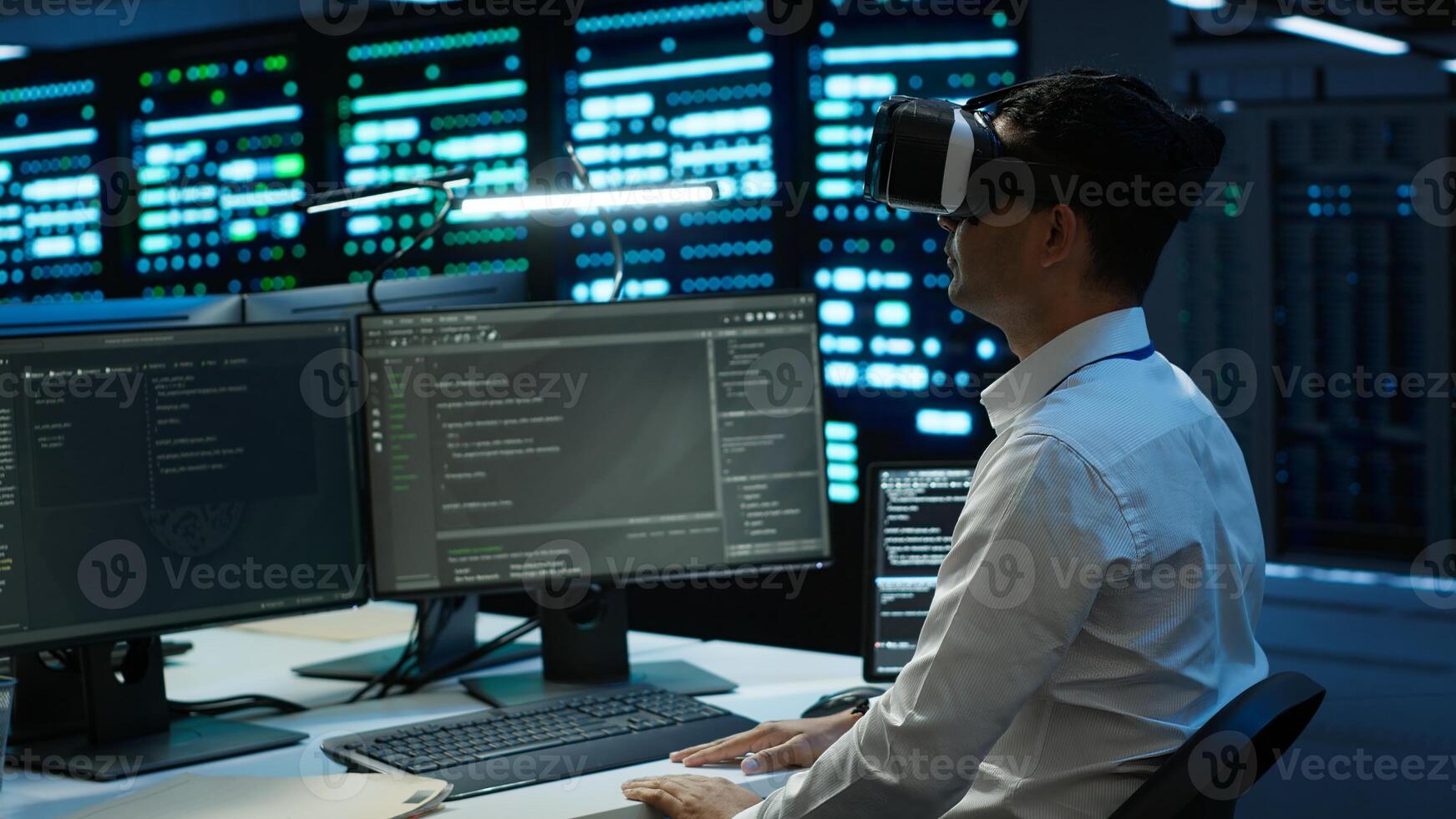 Data center admin responsible for installation of networking systems wearing high tech VR headset. IT worker doing maintenance on server farm gear using virtual reality technology, camera A photo