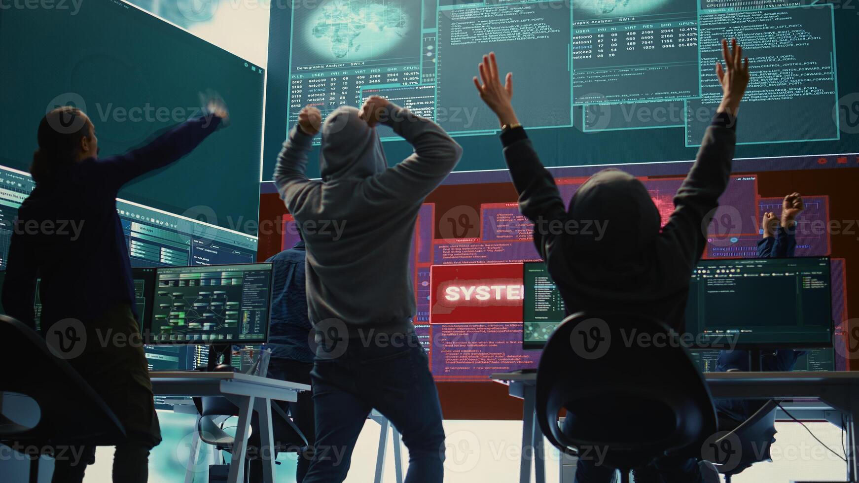 Pleased proud hackers team jumping around after gaining access into rival government database, feeling happy about their success. Professional IT experts hacking network systems. Camera B. photo