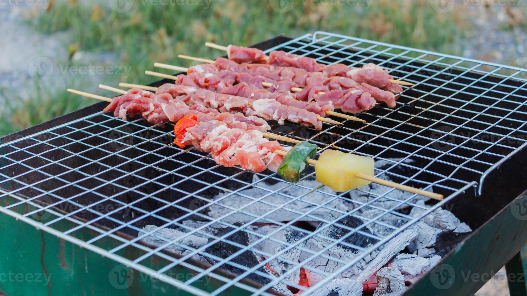Blurred image,Barbecue BBQ skewered on a charcoal grill is a street food that is convenient for a party or picnic and barbecue BBQ is also increasing its popularity in many countries. photo