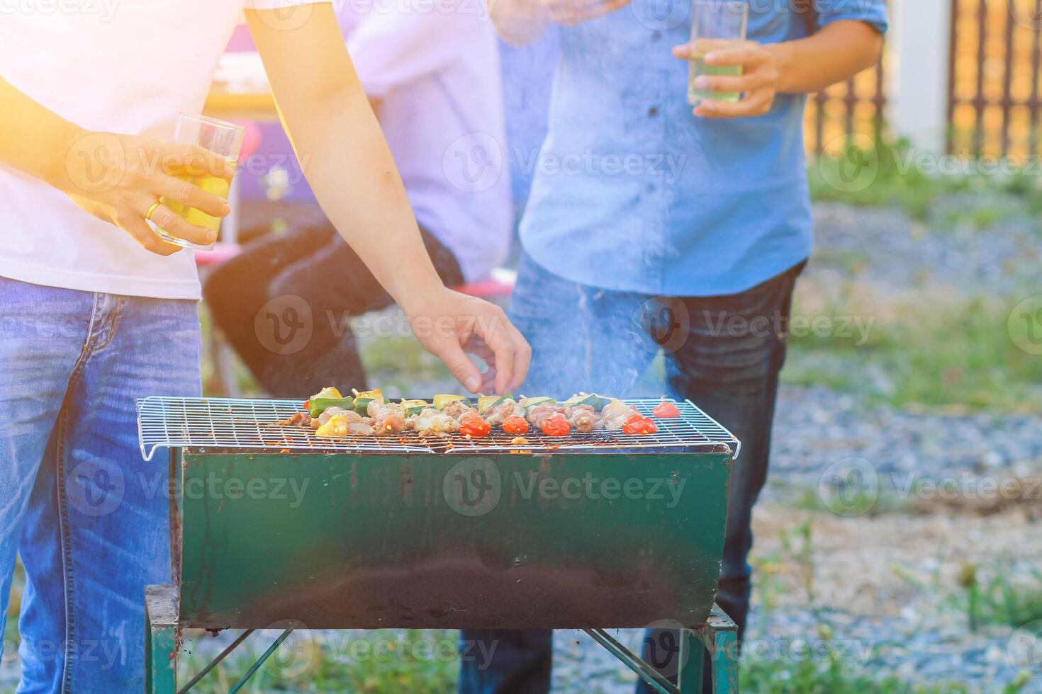Blurred images Barbecue party BBQ After work to celebrate the success that can achieve sales target. A group of colleagues held a barbecue party BBQ and drinking beer to celebrate success. photo