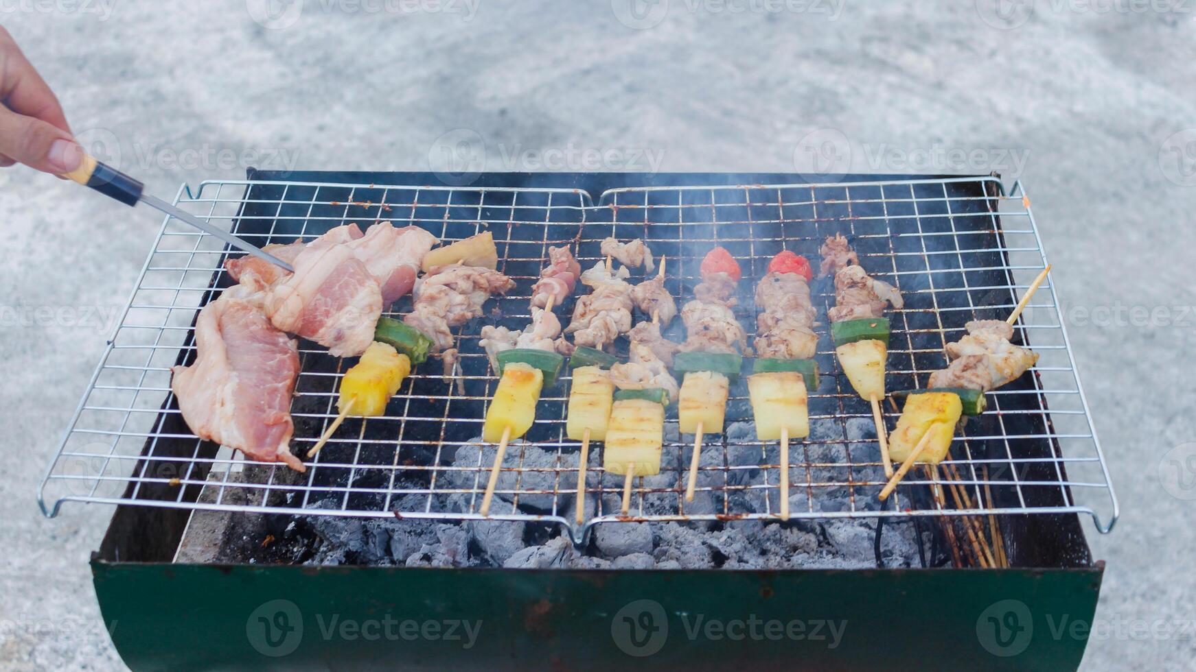 Blurred image,Barbecue BBQ skewered on a charcoal grill is a street food that is convenient for a party or picnic and barbecue BBQ is also increasing its popularity in many countries. photo