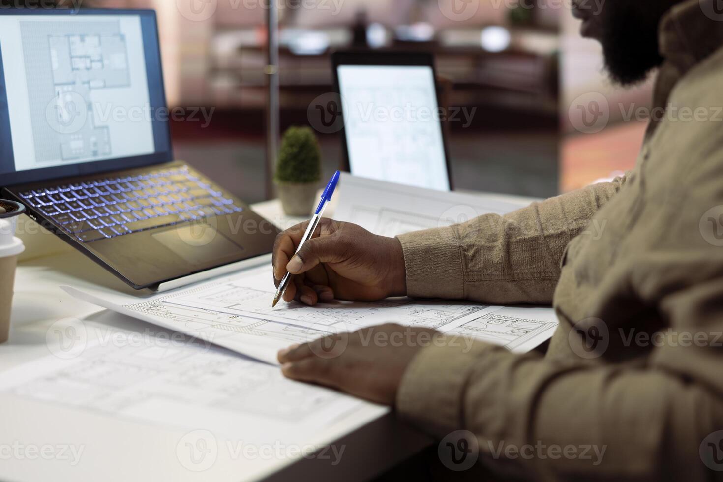 Businessman conducting research and consultation for office space leasing, evaluating blueprints and architectural layout plans to ensure a strategic investment. Office hunt development. photo