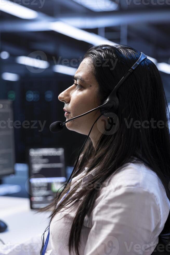Data center technician responsible for providing logistics support to customers. Close up of IT professional overseeing infrastructure systems and communicating with engineers photo