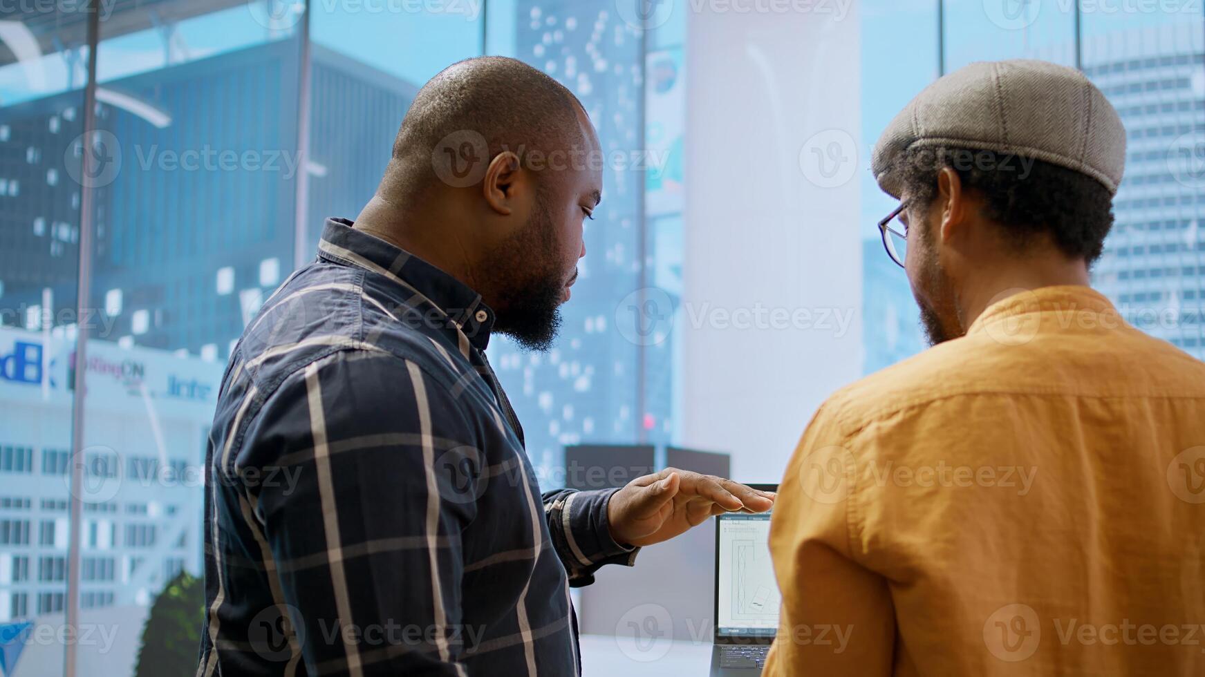 Corporate clients evaluating an investment opportunity in real estate, reviewing architectural blueprints and discussing the best strategies for office relocation and creative development. Camera A. photo