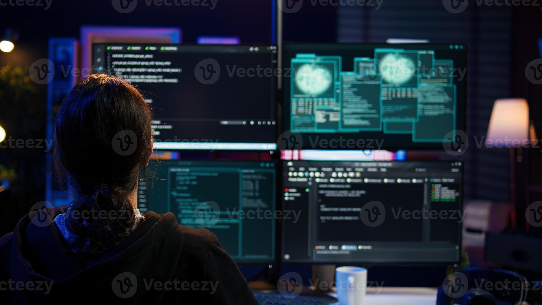 Dangerous hacker writing lines of code on PC from secret apartment, trying to get past security systems. Evil software developer building scripts that can hack devices, camera B photo