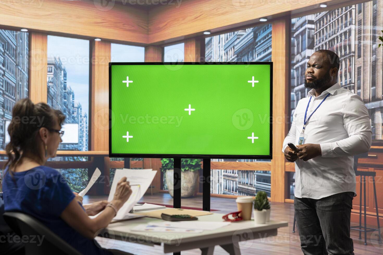 Financial advisor presenting a copy space mockup display to old people, discussing about retirement packages suitable for their income. Securing pension and life savings in modern office. photo