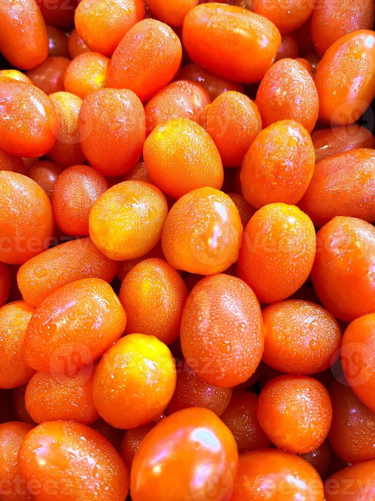 organic red tomatoes texture background ideal for fresh produce and healthy eating concepts, cherry tomatoes on the market, red tomatoes background photo
