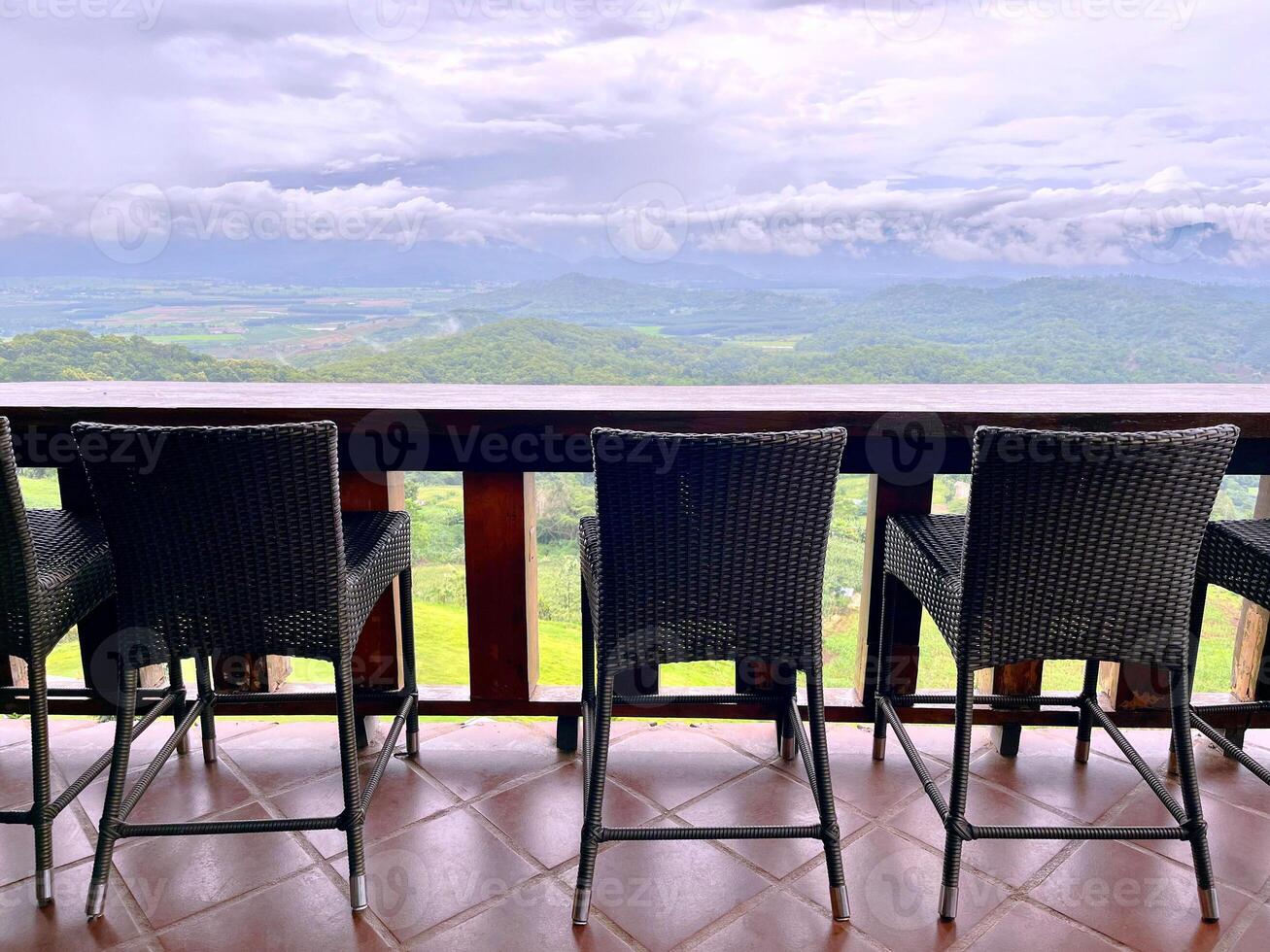 table and chairs, Outdoor mountain villa balcony deck, with natural views of the mountains, the terrace overlooking the mountains, empty wooden terrace overlooking the forest and mountains photo