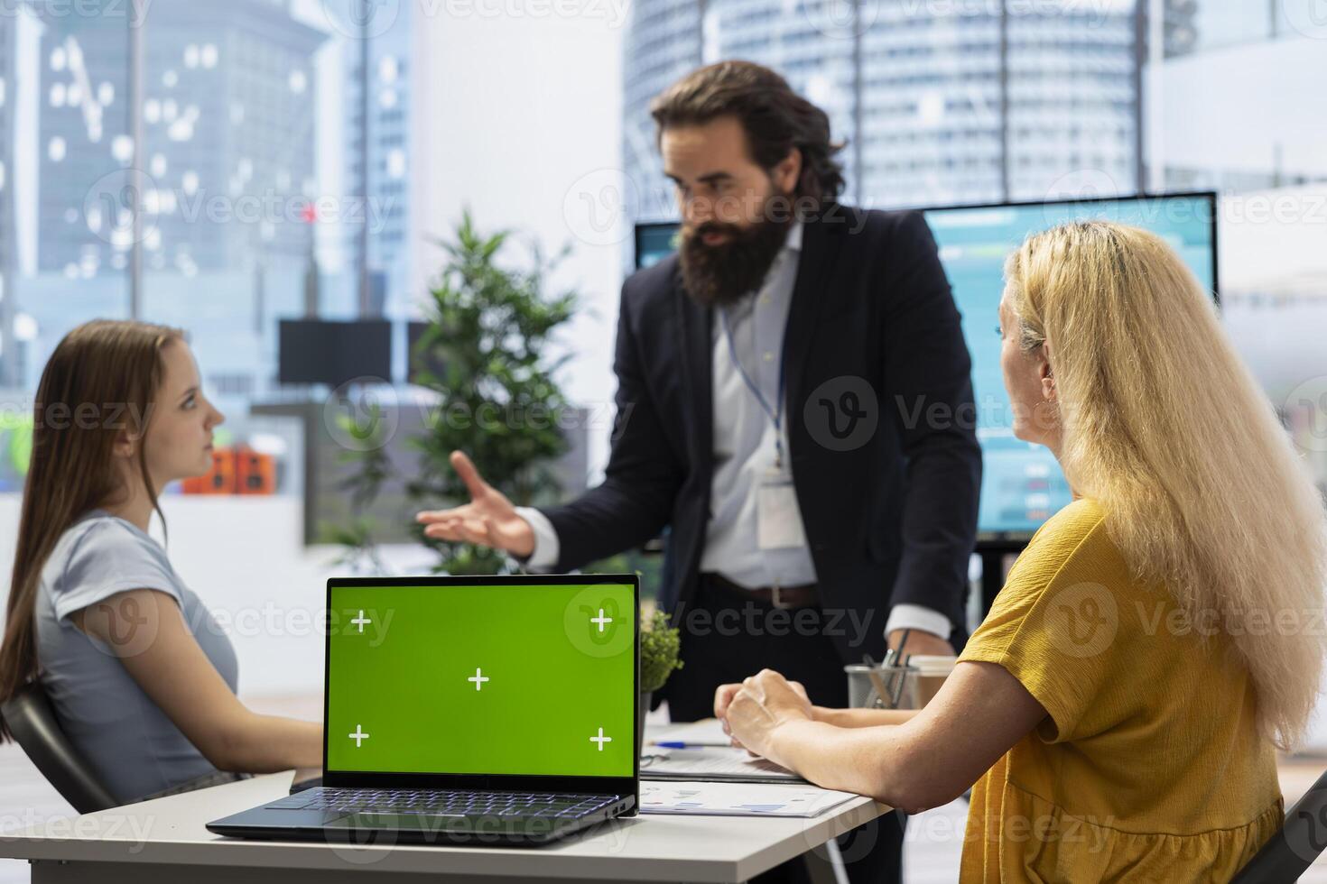 Financial advisor establishing emergency fund for clients using green screen laptop. Agent in office using chroma key notebook to provide financial security in case of unexpected emergencies photo