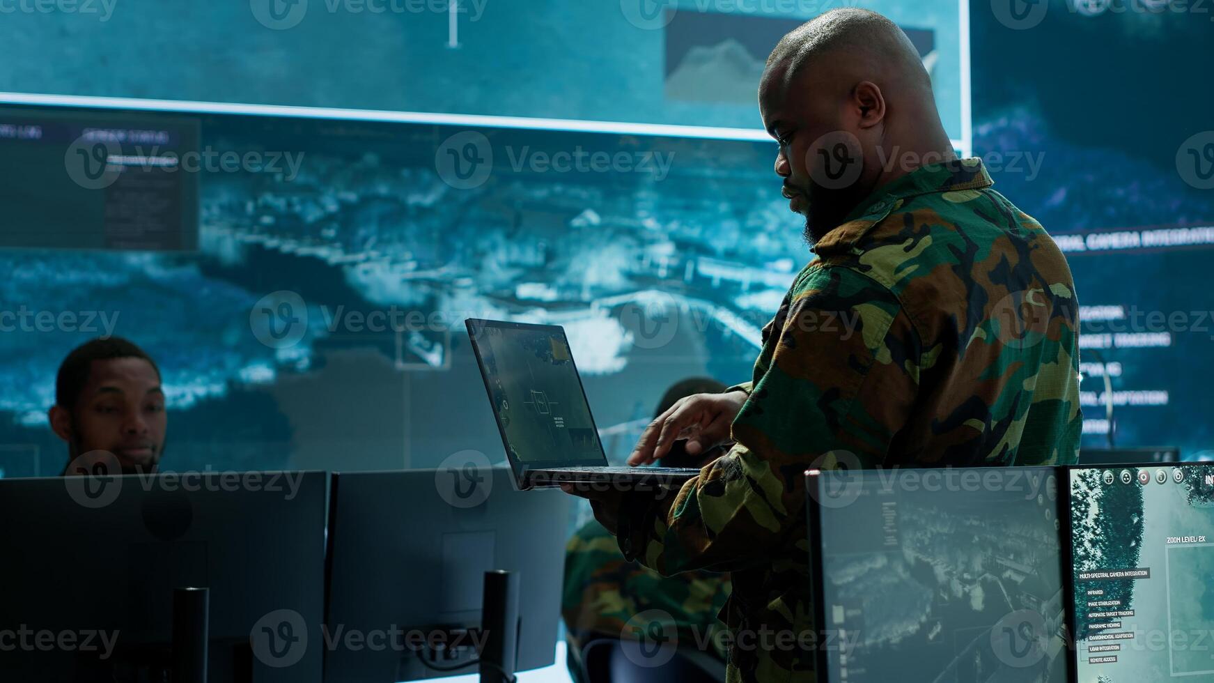 Military specialists work in a high tech command post center, focusing on cybersecurity, surveillance and data protection to ensure the security and integrity of national information. Camera A. photo