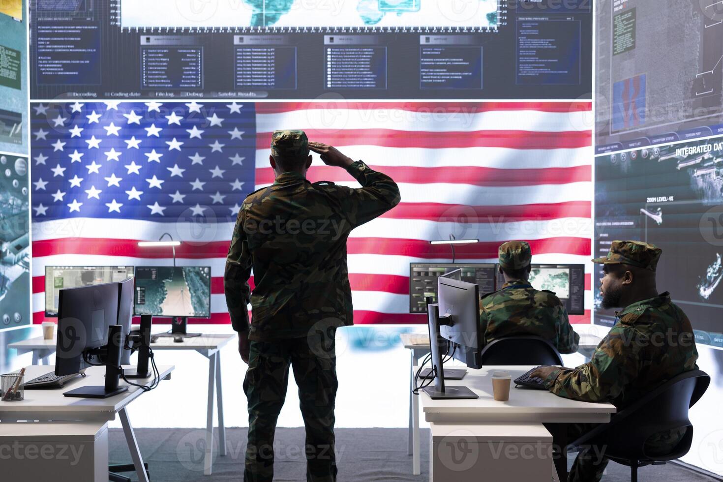 American military personnel supervising cyber warfare activity in high tech office, examine top secret intelligence on big screen. Governmental experts manage hybrid war, conflict prevention. photo