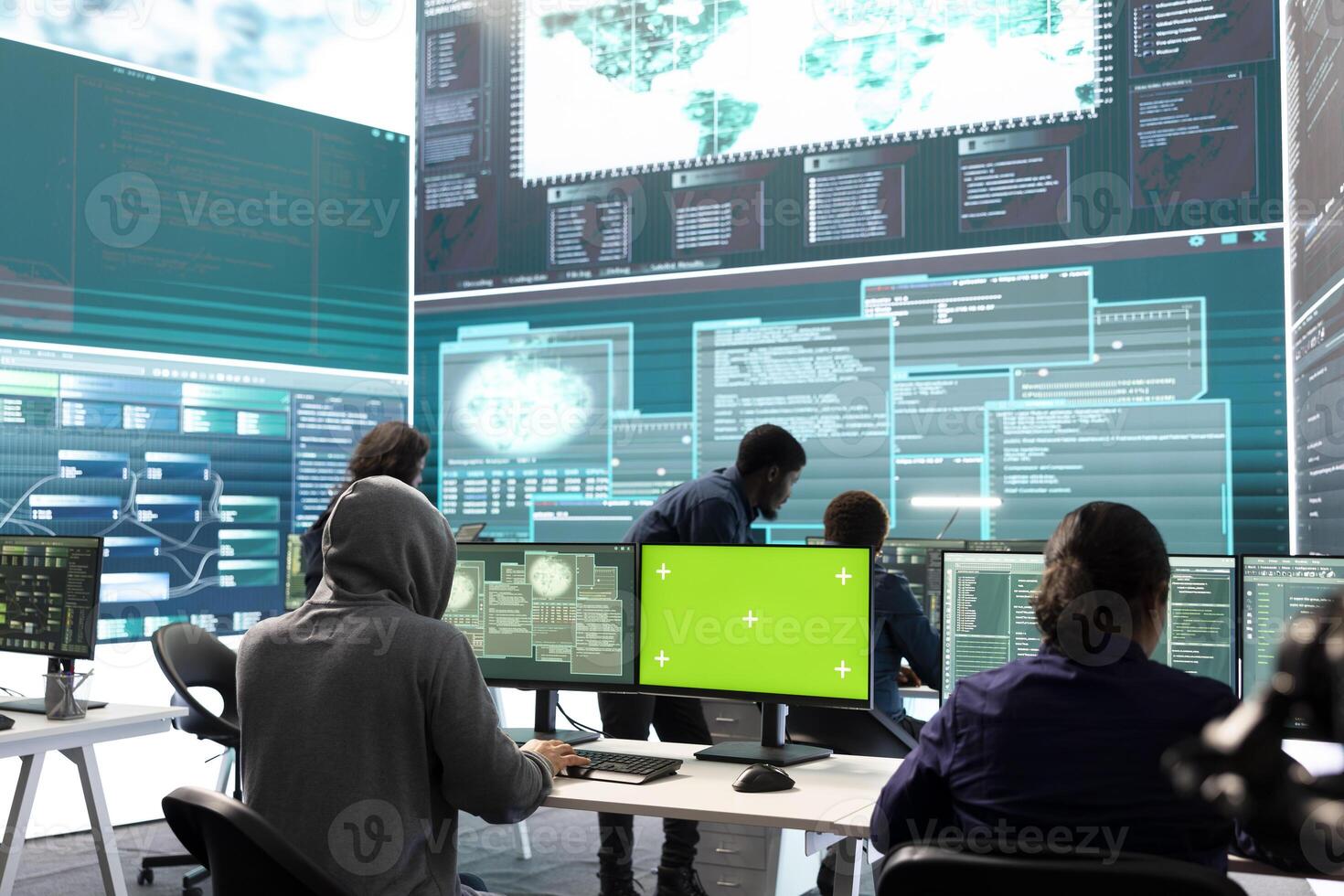 Team of governmental hackers look at green screen in high tech agency office, working together on hacking database systems for cyberwarfare activity. Experts conducting illegal scams. photo