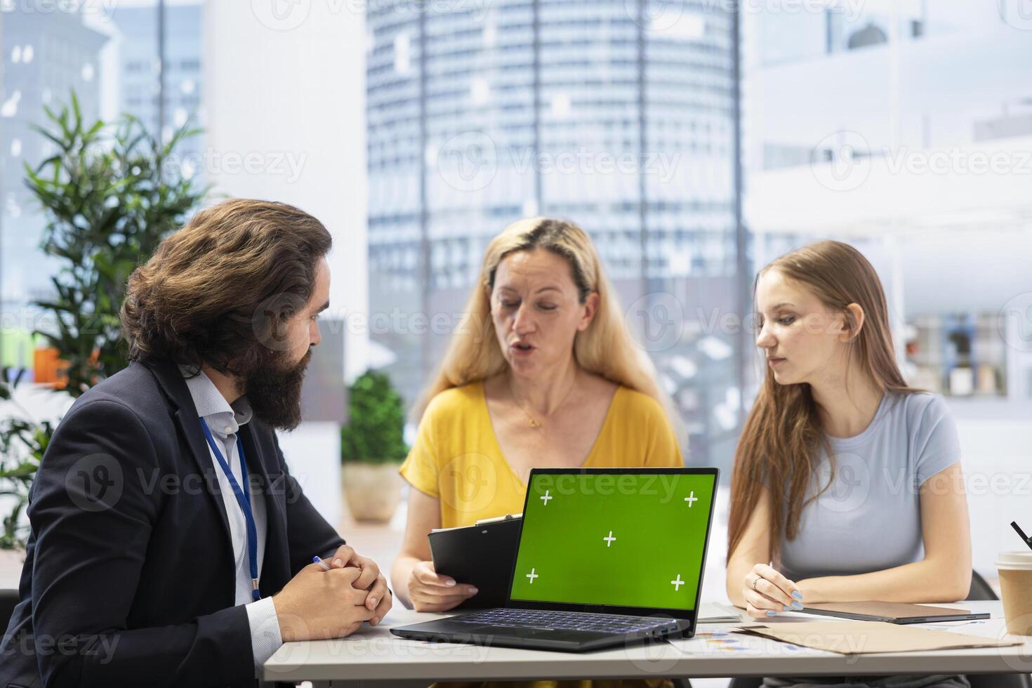 Financial advisor using green screen laptop to help family maintain budget, avoiding overspending. Agent in office using software on chroma key notebook to build emergency fund plan for clients photo