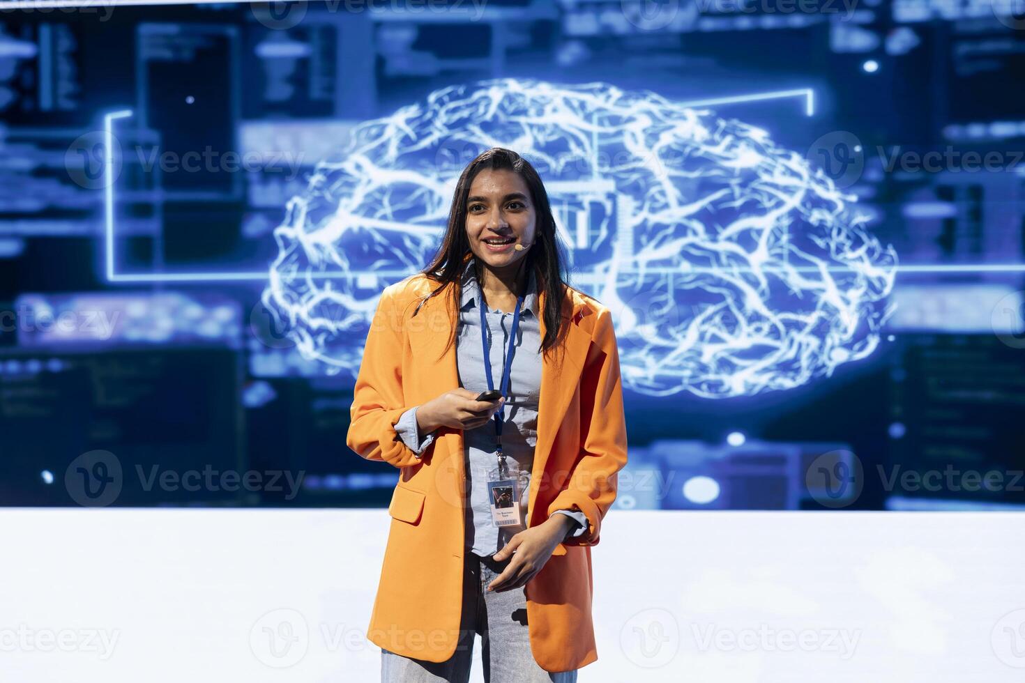 Smiling presenter talking at AI summit using mic, sharing industry expertise to inspire audience. Technician exploring latest artificial intelligence products and services at tech event photo