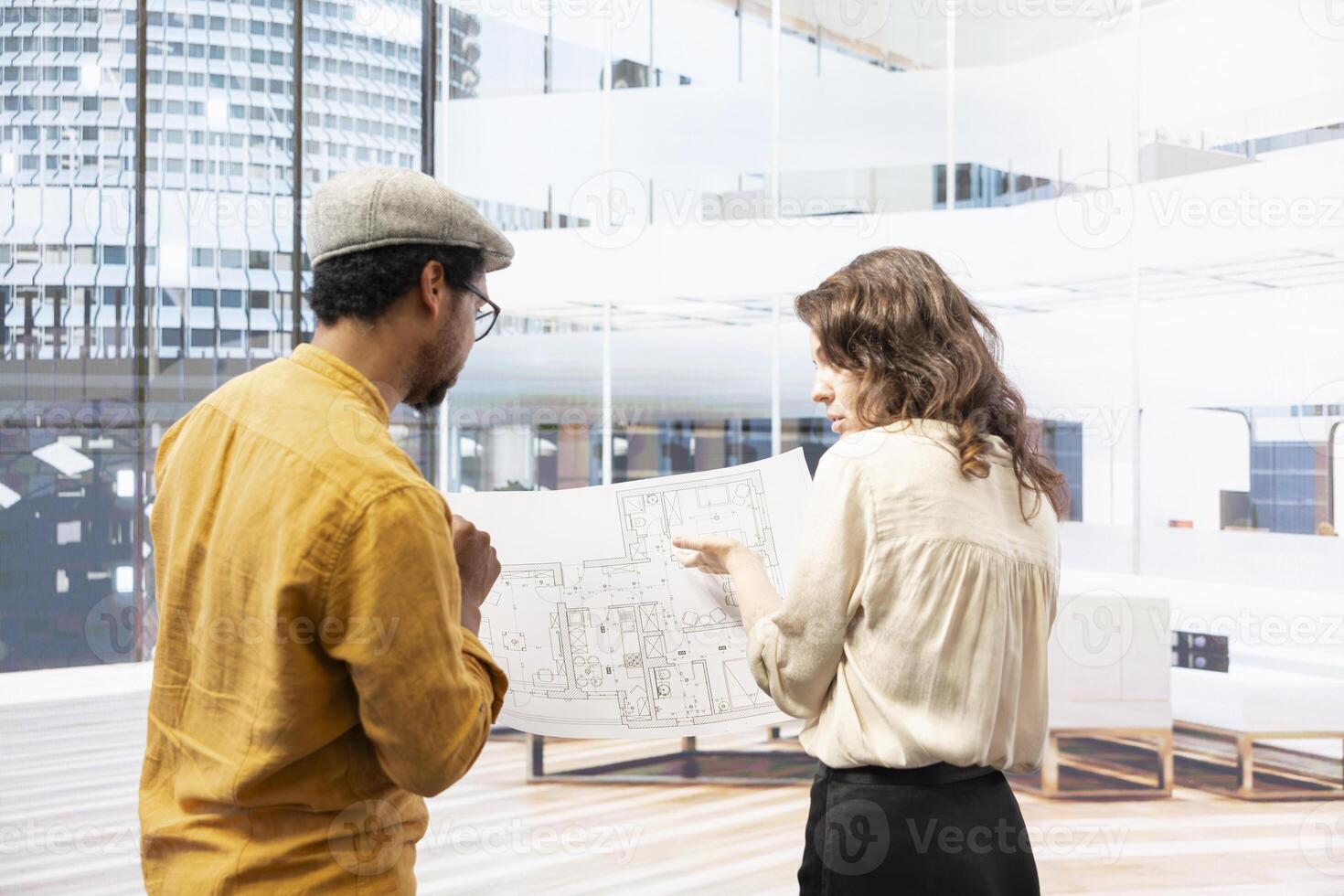 Real estate broker and entrepreneur meeting on an office hunt inside urban building, touring potential relocation property and discussing investment opportunity. Rental agreement. photo