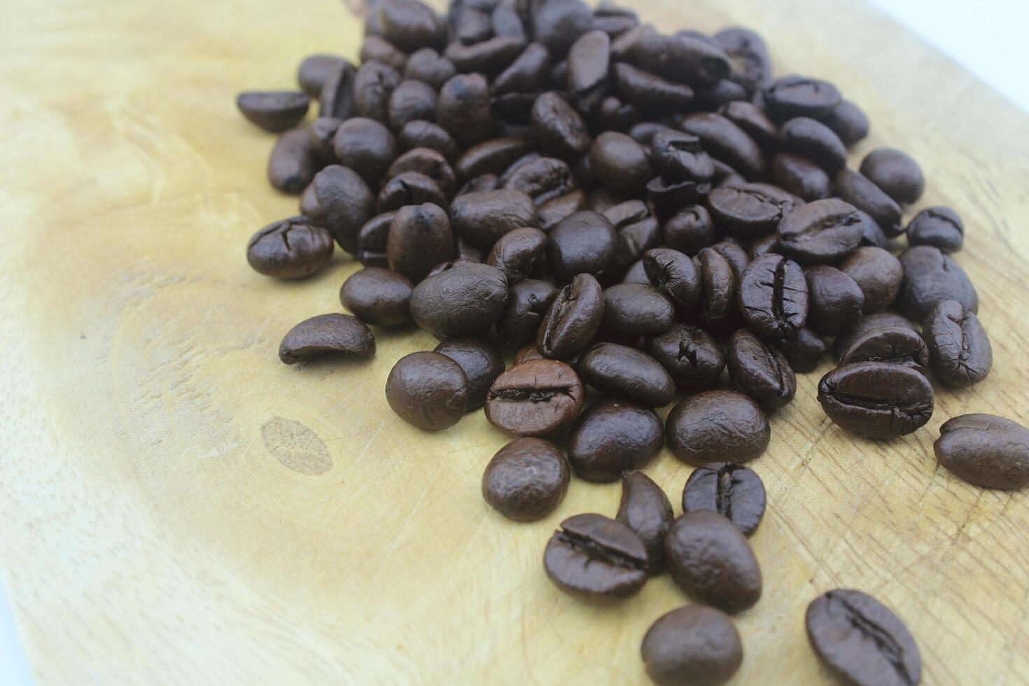 Coffee beans on the wooden floor photo