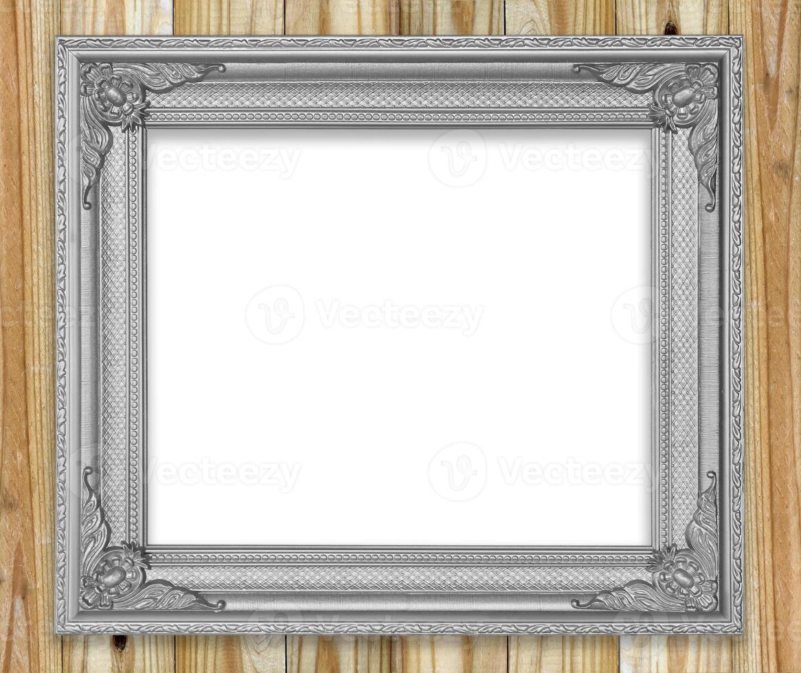 Antique gray frame on wooden wall Empty picture frame on white wooden wall. photo