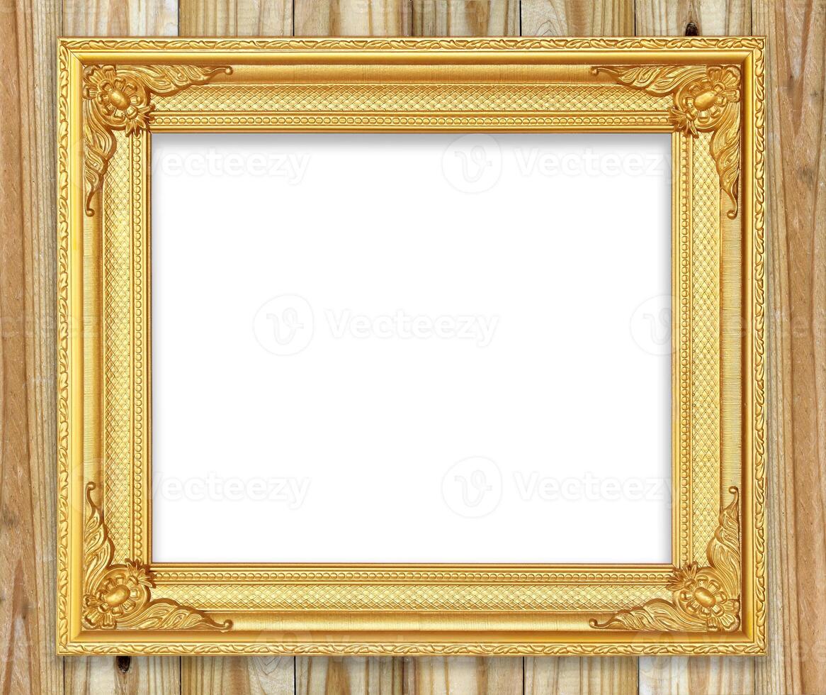 Antique gold frame on white wooden wall.Empty picture frame on white wooden wall. photo