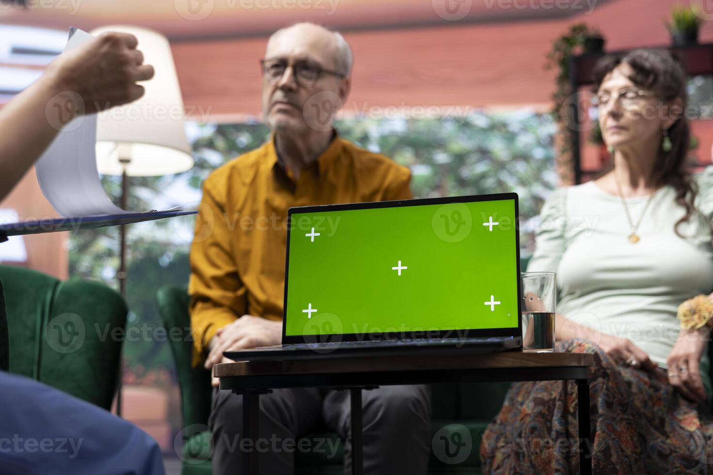 Social caretaker visiting elderly people patients at their home, using isolated mockup and doing a consultation to give treatment and vitamins for wellness. Nurse talking to old couple. photo