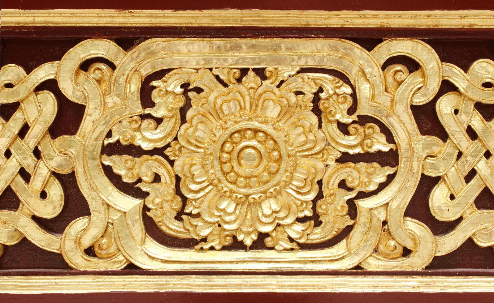 Pattern of wood frame carve flower on black background photo