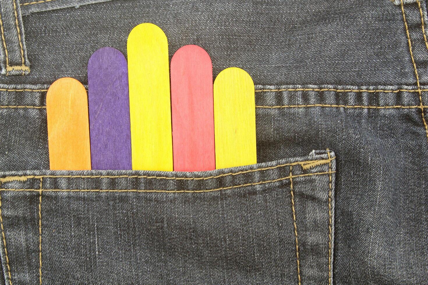 Colorful wood ice lolly sticks, Ice cream sticks, in bag jean background photo