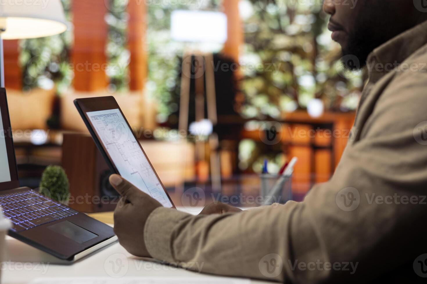 Entrepreneur planning an office relocation evaluating architectural blueprints, consulting with interior designers to create an inspiring workspace. Hunting for property leasing. photo