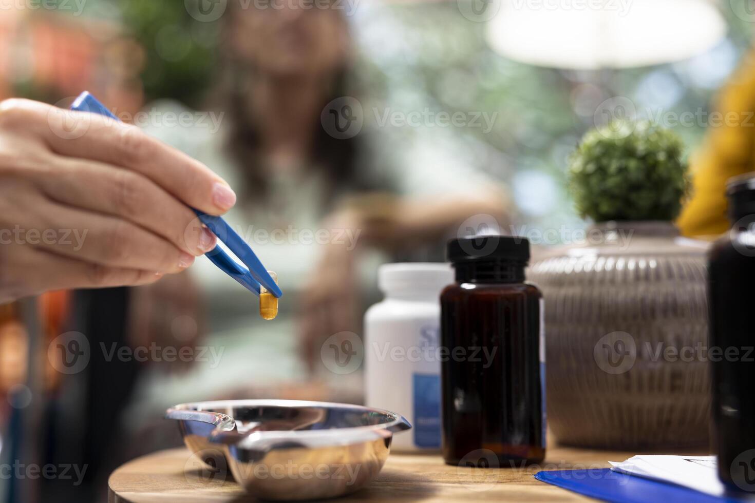 Social caregiver separating the medicaments and supplements pills, preparing daily doses for both senior people at home. Putting the capsules in two different bottles, healthcare medicine. Close up. photo