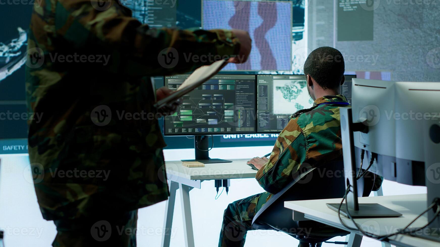 Skilled team of military specialists operate advanced technology and a big screen in a control center, managing surveillance footage via cctv radar system. Safety mission department. Camera A. photo