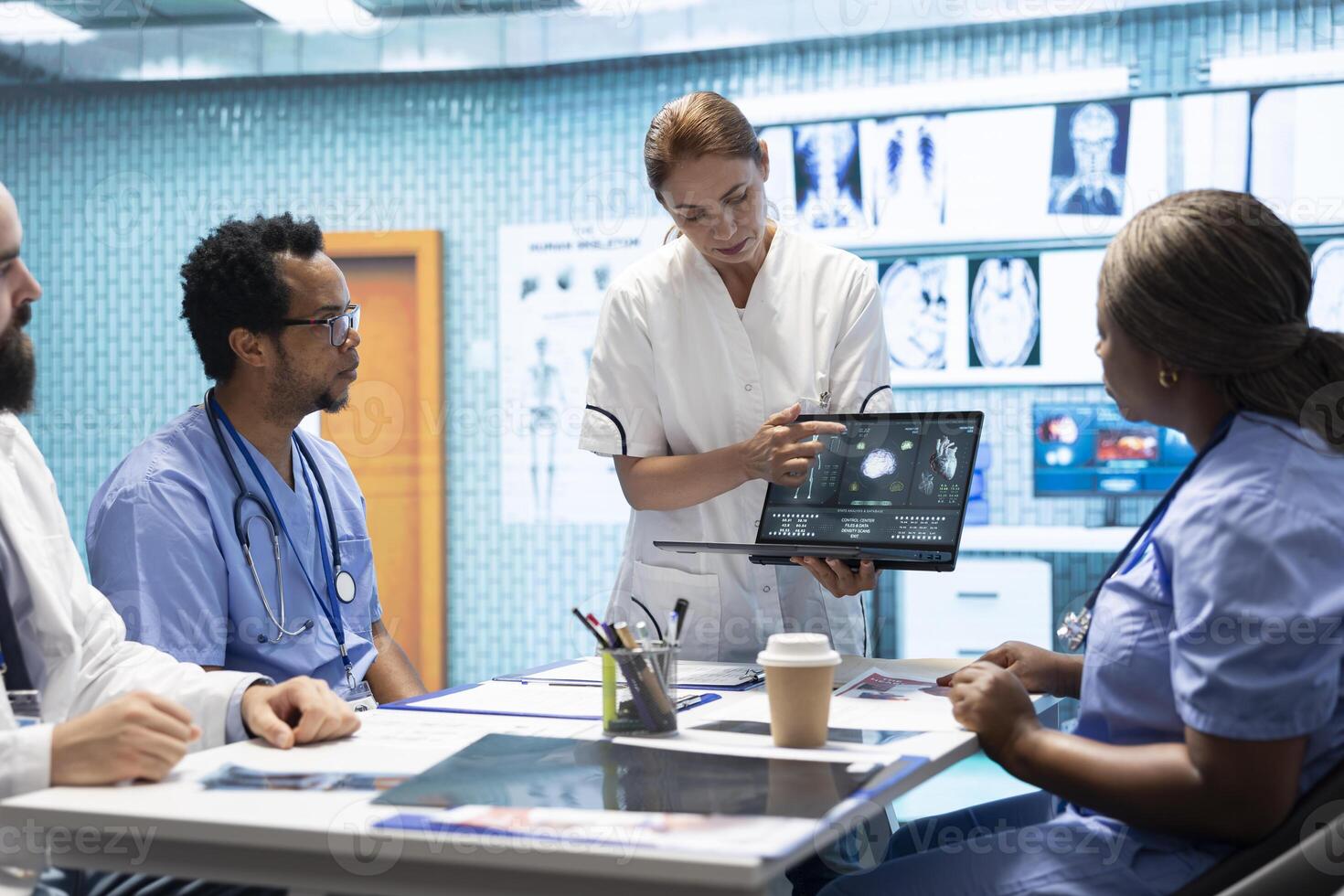 Team of specialists reviewing ecg results in a meeting at a private clinic, analyzing cardiovascular system on a radiography for disease prevention. Consulting cardiac scans and records. photo
