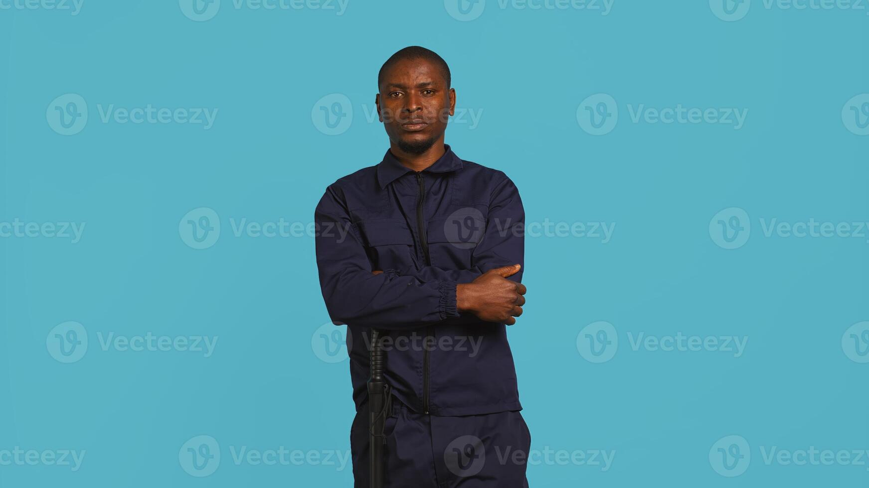 Portrait of security staff member tasked with evicting trespassers while following legal protocols. Patrolling agent maintaining secure environment, studio background, camera B photo