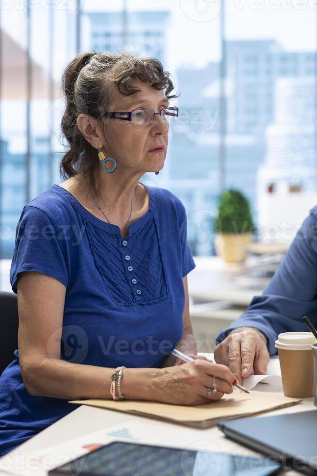 Elderly people in a modern office setting meeting with financial advisor, discussing retirement plans and covering pension options or investments. Securing their life savings. photo