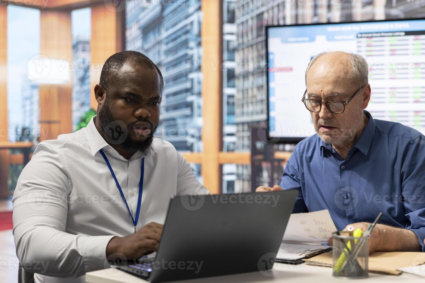 Old people receiving professional advice on retirement options, discussing investment opportunity and pension plans. Elderly couple in a meeting with broker about securing their savings. photo
